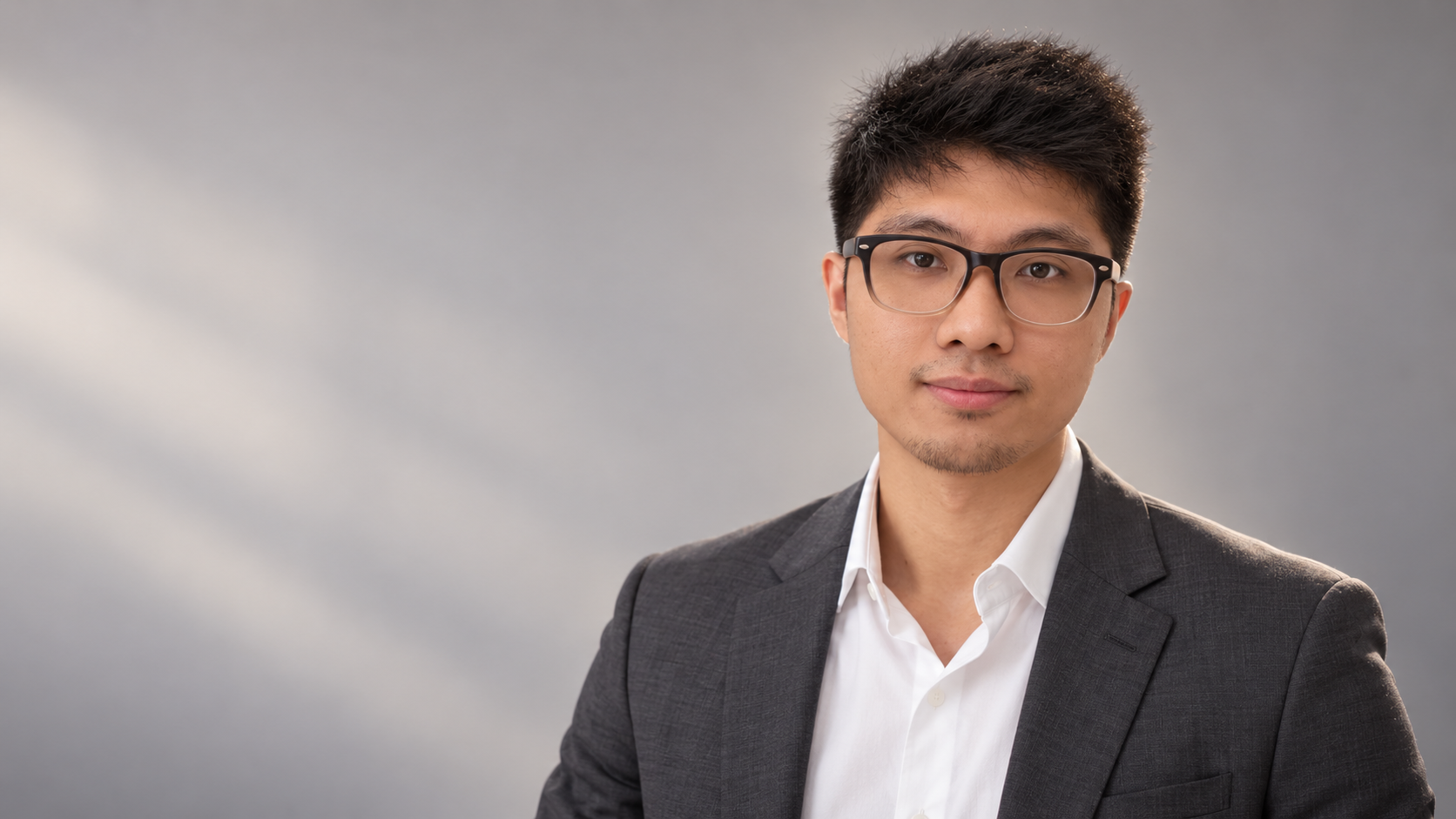 Cedrix wearing a suit and glasses